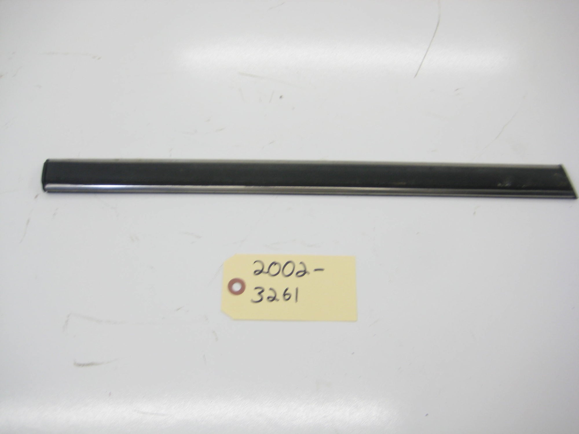 Right Passenger Rear Quarter Bump Trim In Front Of Tire